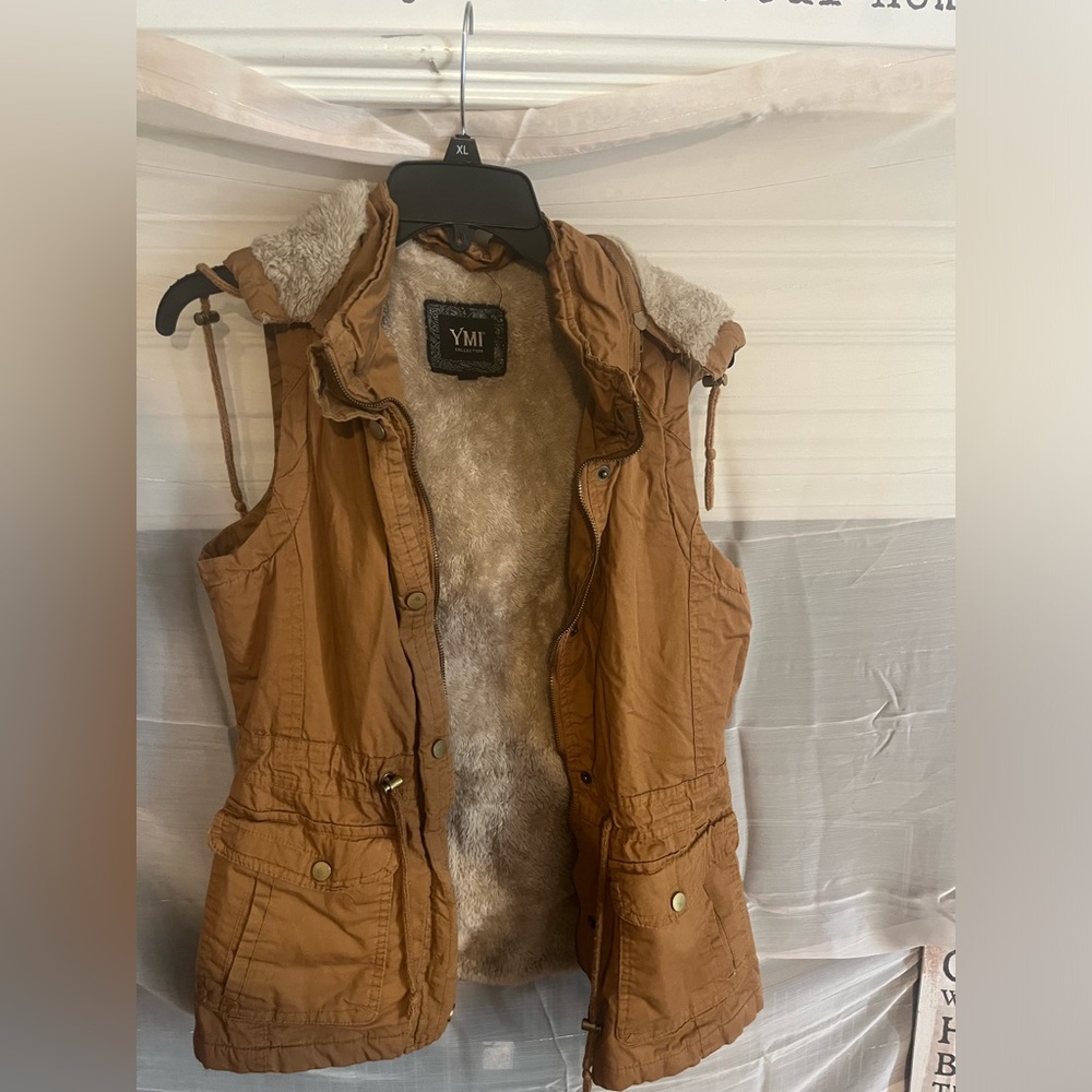 Great fur lined vest with removable hood and front zipper and buttons.